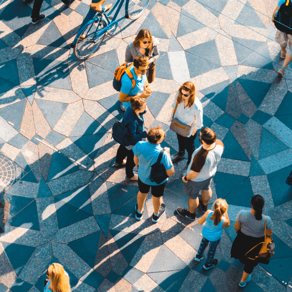Arial view of students standing on patterned sidewalk 