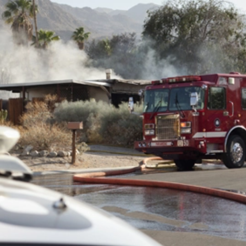 Mountainside home on fire, fire truck in front of house