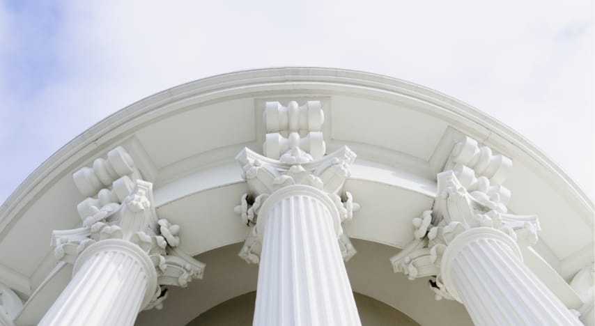 Upwards view of decorative columns on a white building 