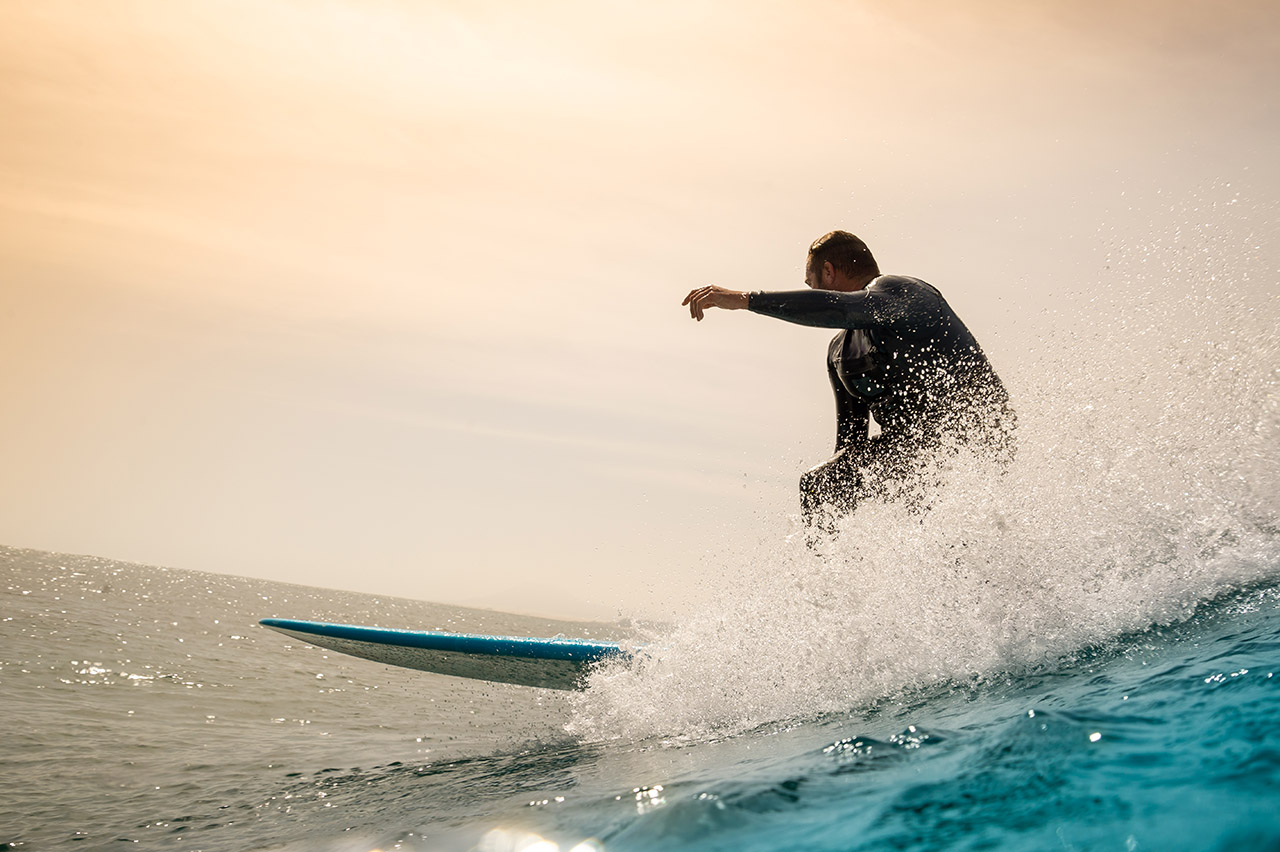 Surfer riding waves on the island of fuerteventura in the Atlantic Ocean, Canary Islands