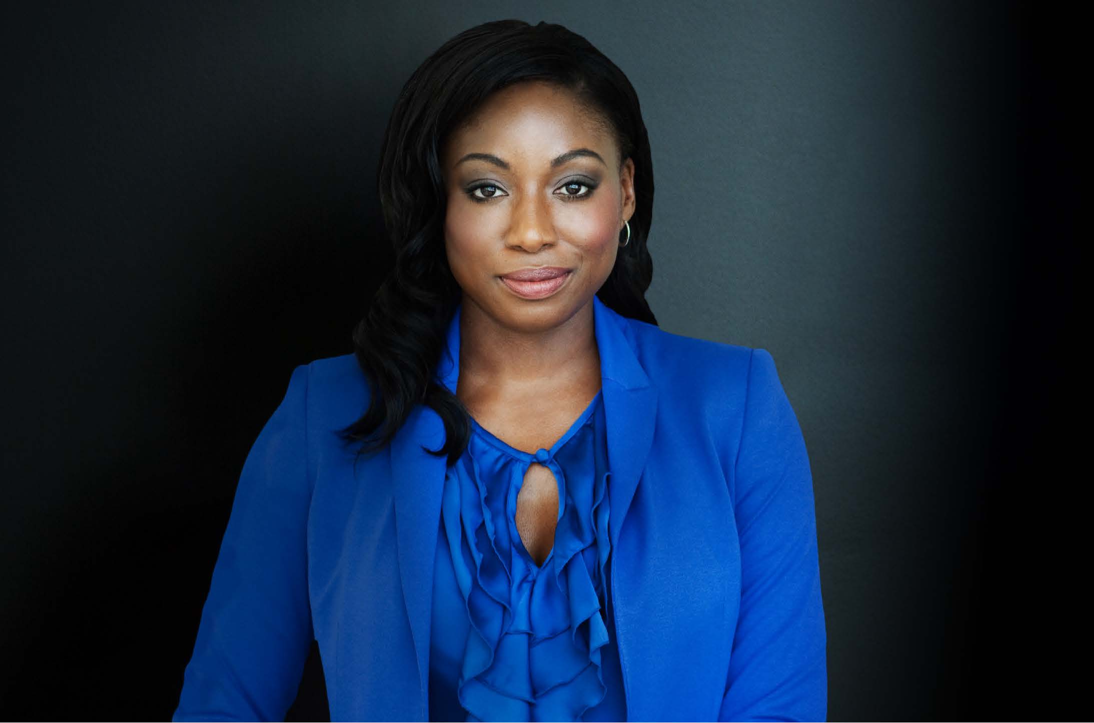 Black women in blue suit welcoming a conversation